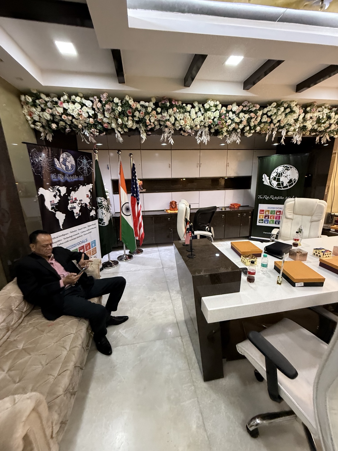 Office reception with a desk, seating and flags