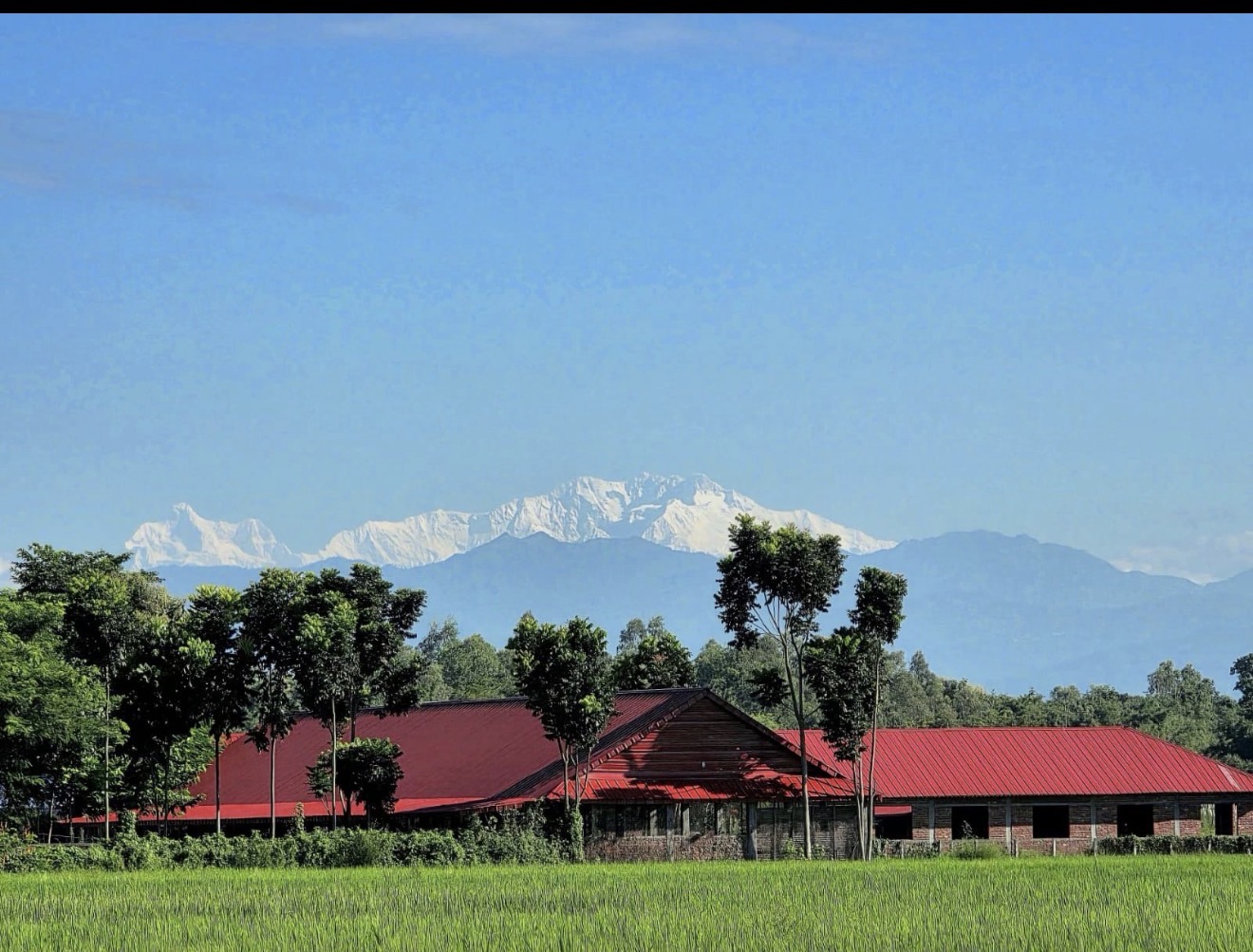 Buildings with a mountain backdrop — Ratuwamai, Koshi Province, Nepal