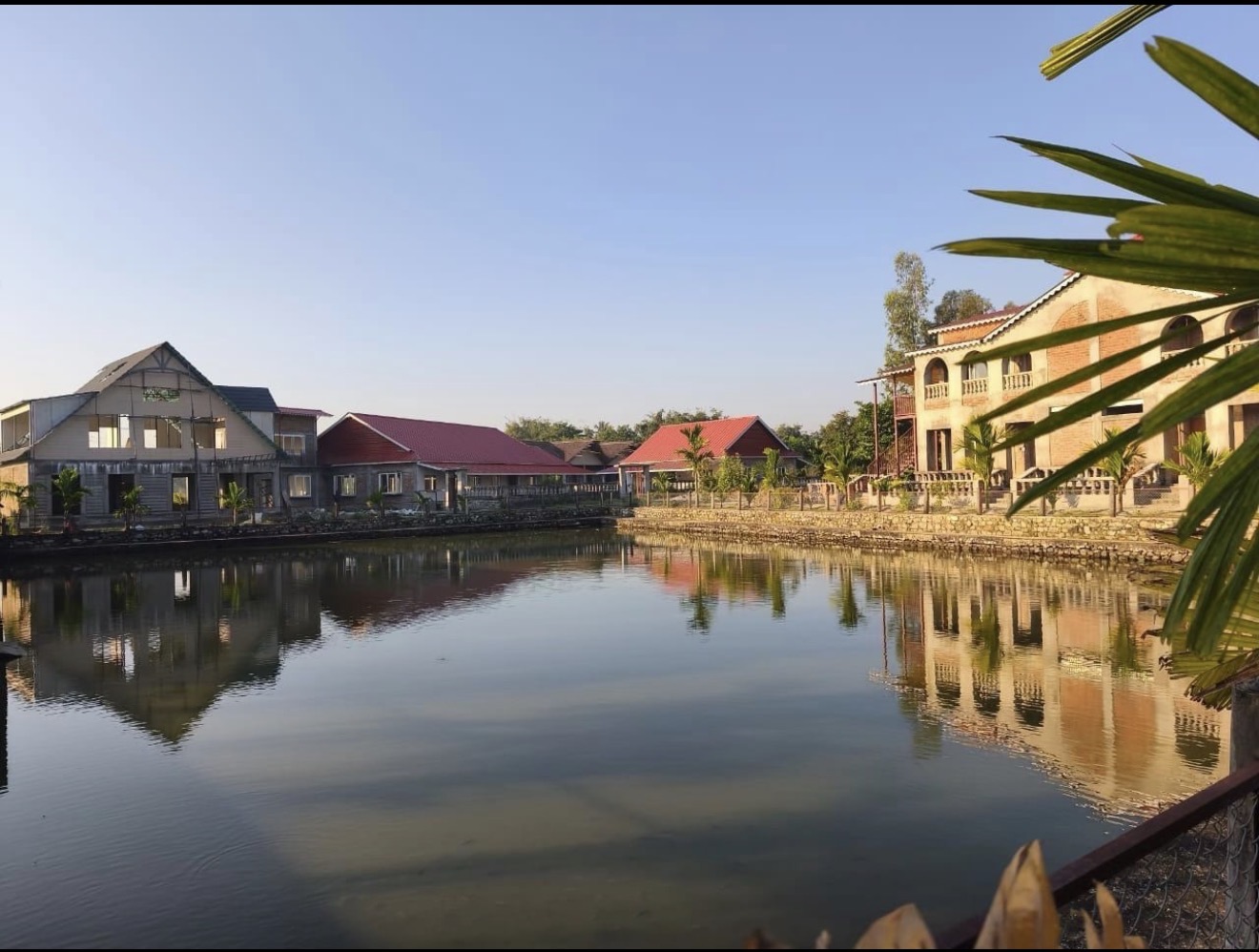 Buildings reflected in the pond — Ratuwamai, Koshi Province, Nepal