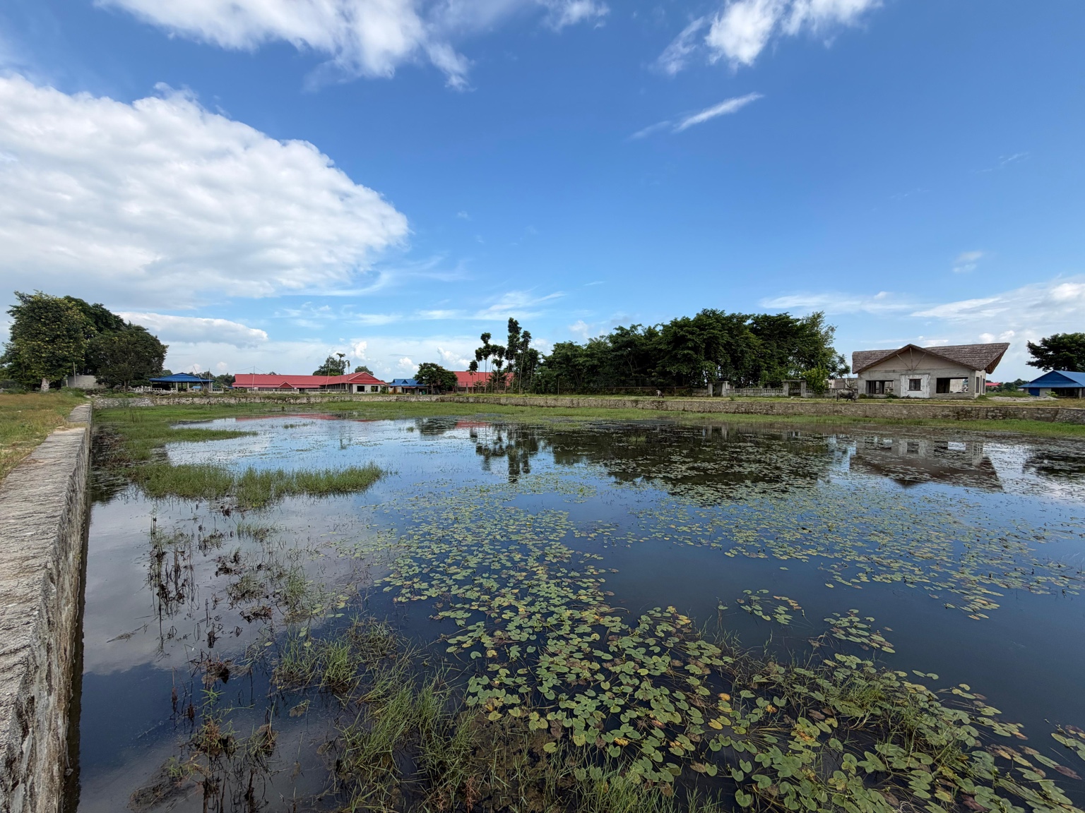 Pond and buildings across the site — RRSC Sustainability Development Centre, Ratuwamai, Koshi Province, Nepal