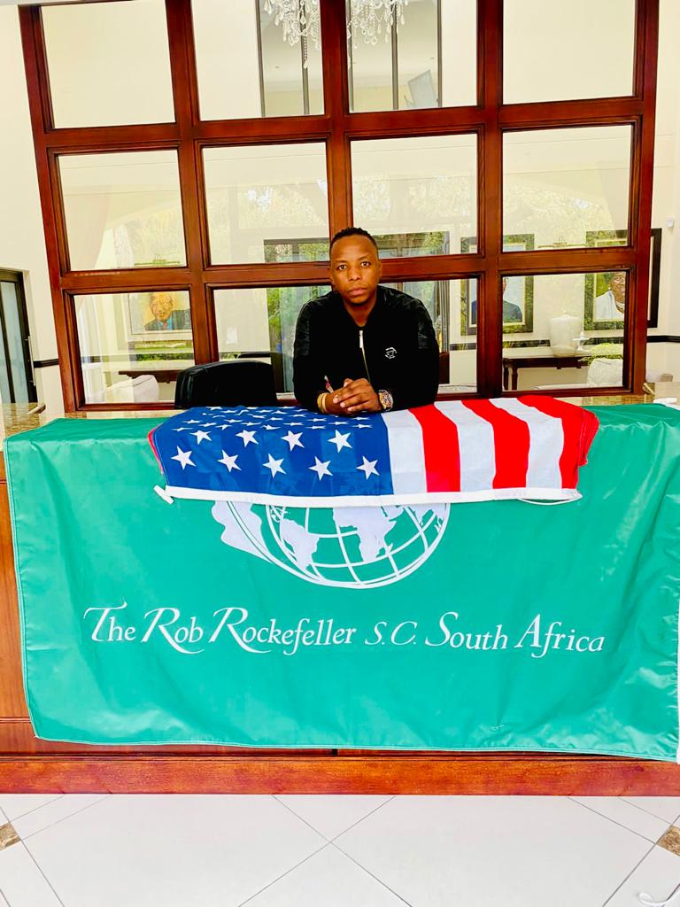A desk with the United States flag and RRSC South Africa banner