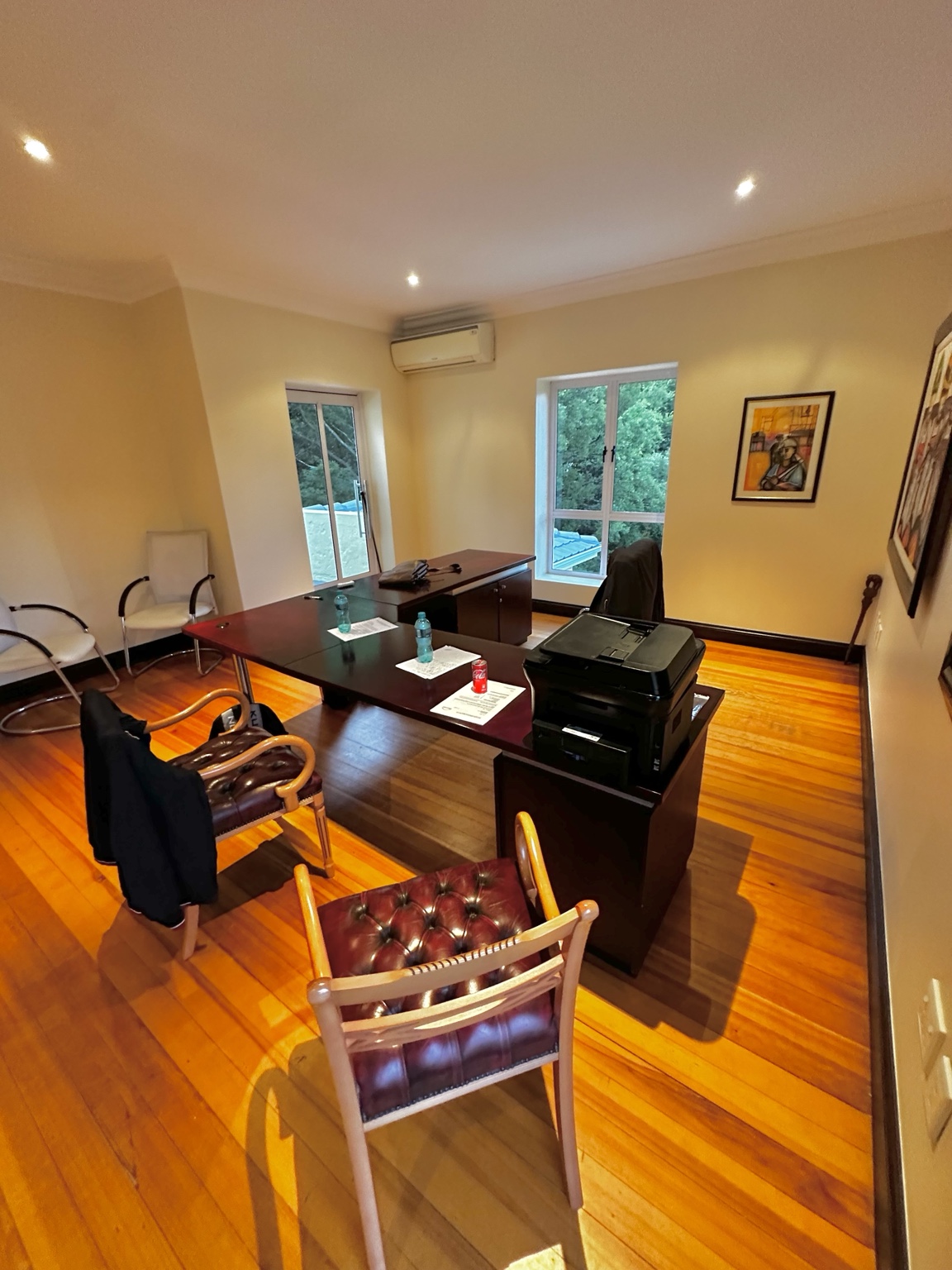 Office workspace with desks, seating and a printer