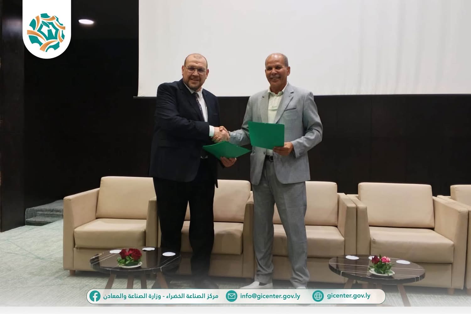Representatives exchanging green agreement folders at the Green Industry Centre signing ceremony