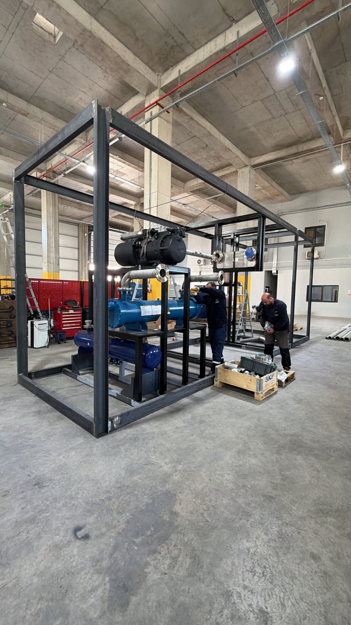 Full height view of equipment under assembly in its steel support frame.