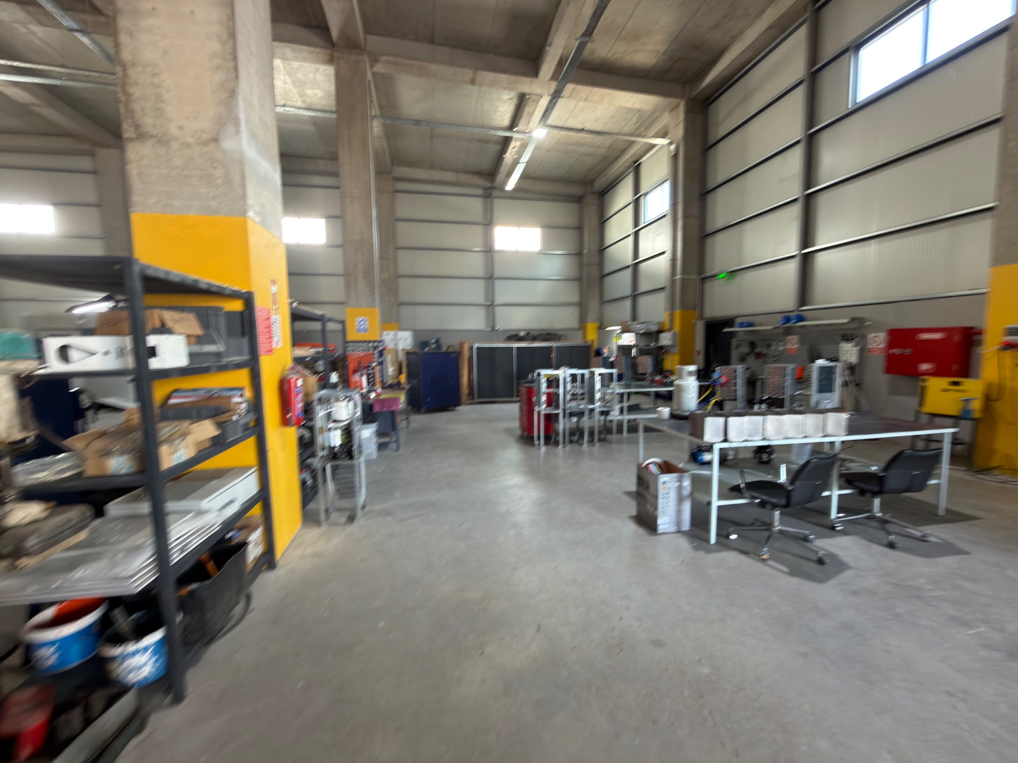 View along the workshop floor, with workbenches and components.