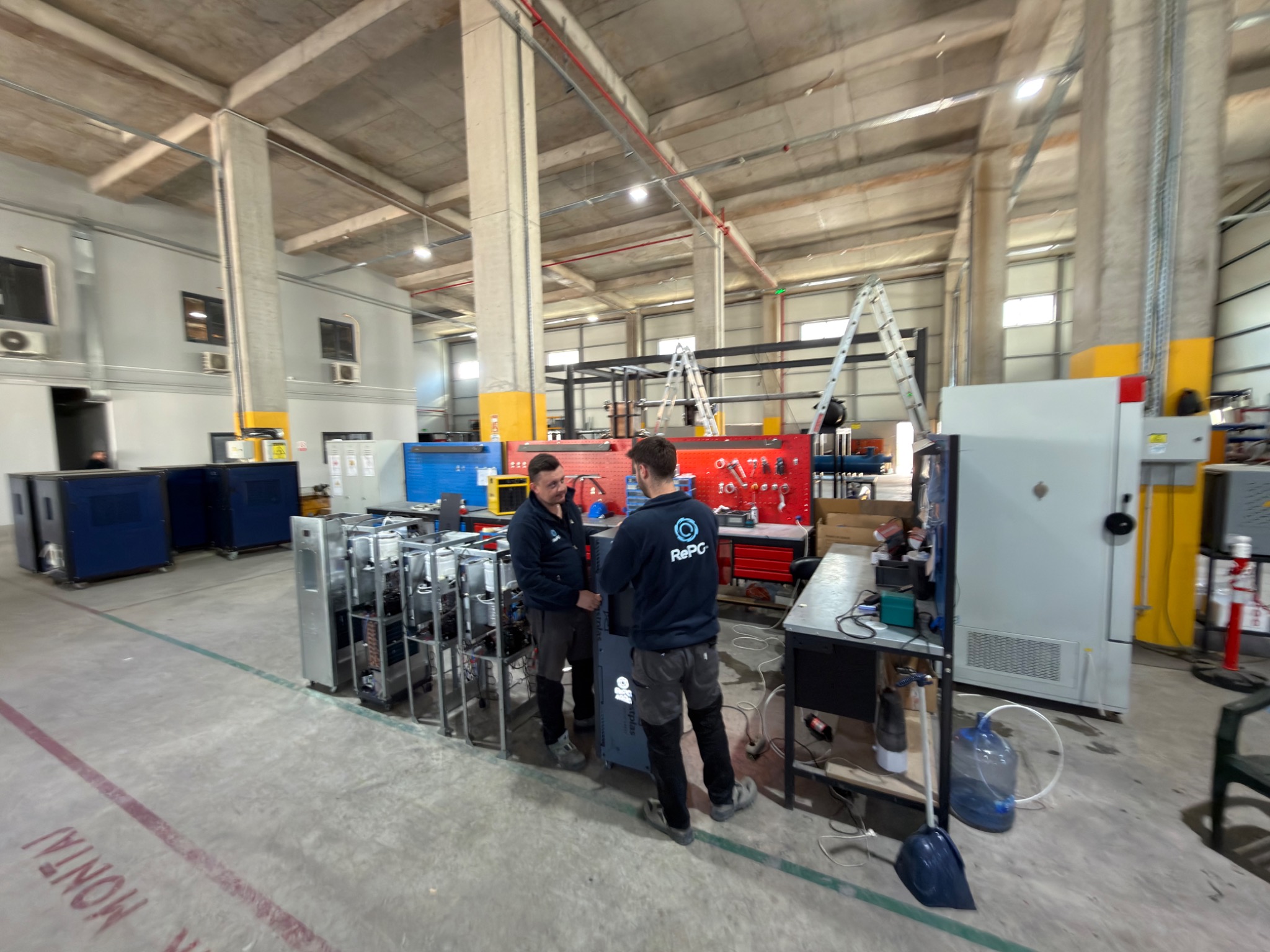 Technicians and equipment in the workshop assembly area.