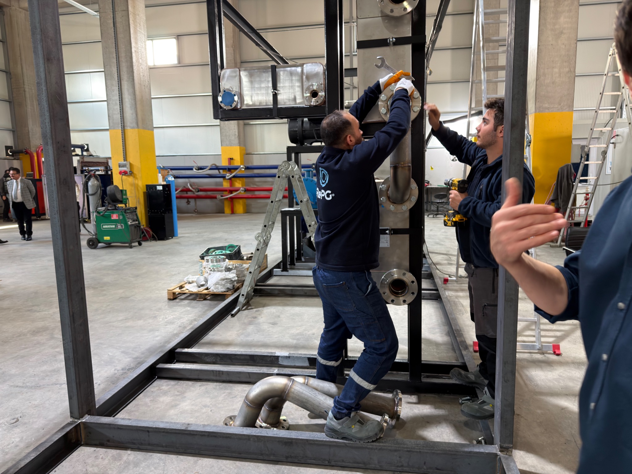 A technician fitting a component within the equipment frame.