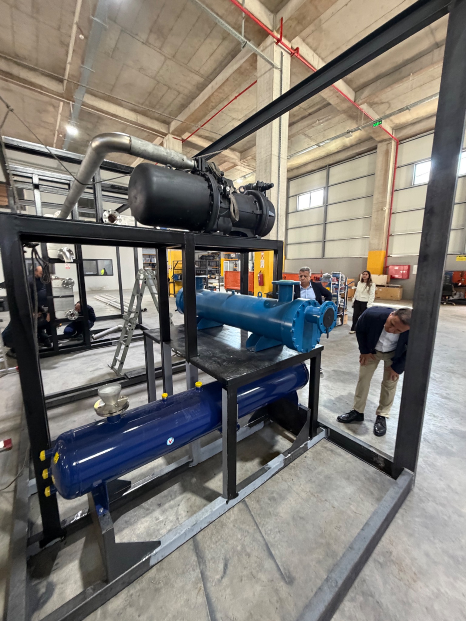 Close view of the equipment assembly, steel frame and connected piping.