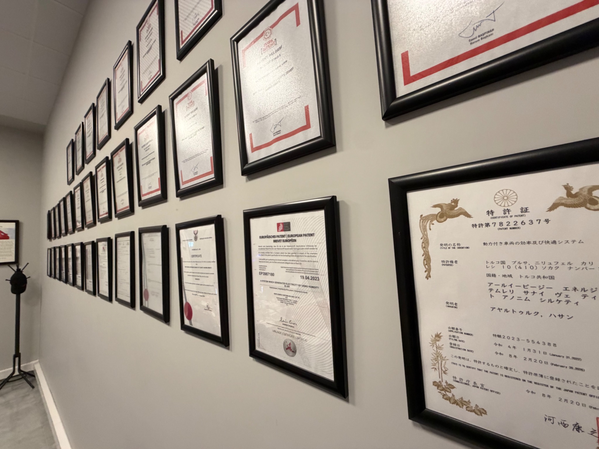 Rows of framed patent certificates displayed on a wall at the RePG Engineering Center.