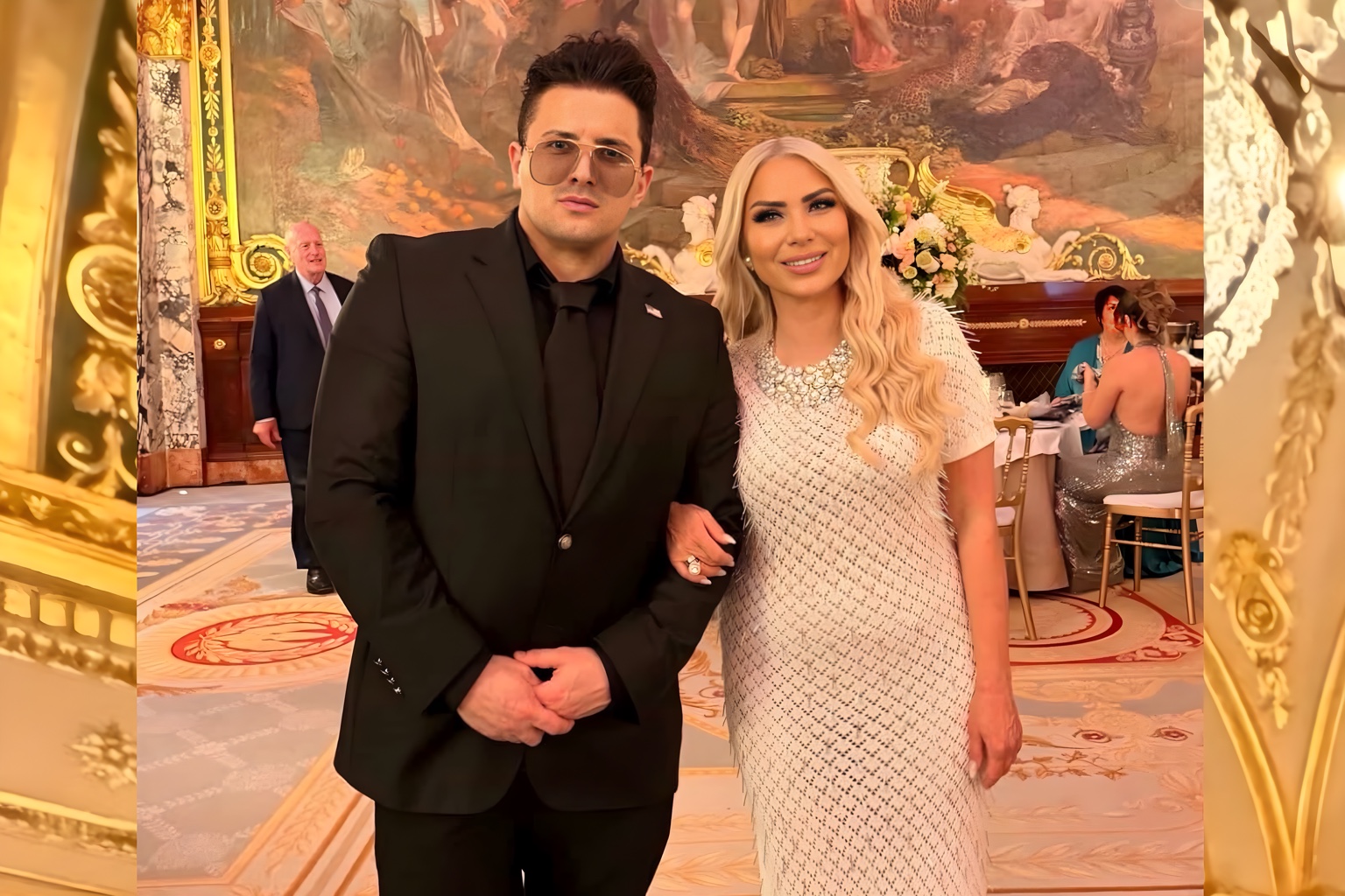 Two guests photographed together inside the Salle Empire during the gala