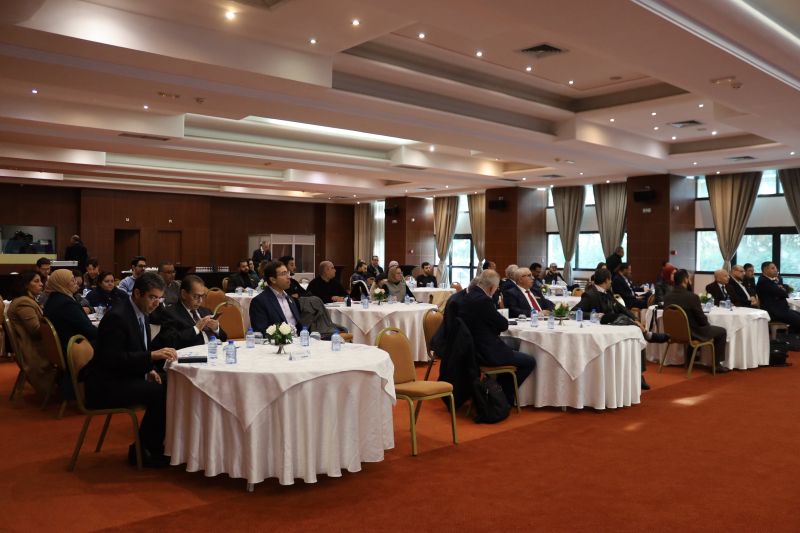 Participants seated around tables in the forum's conference hall