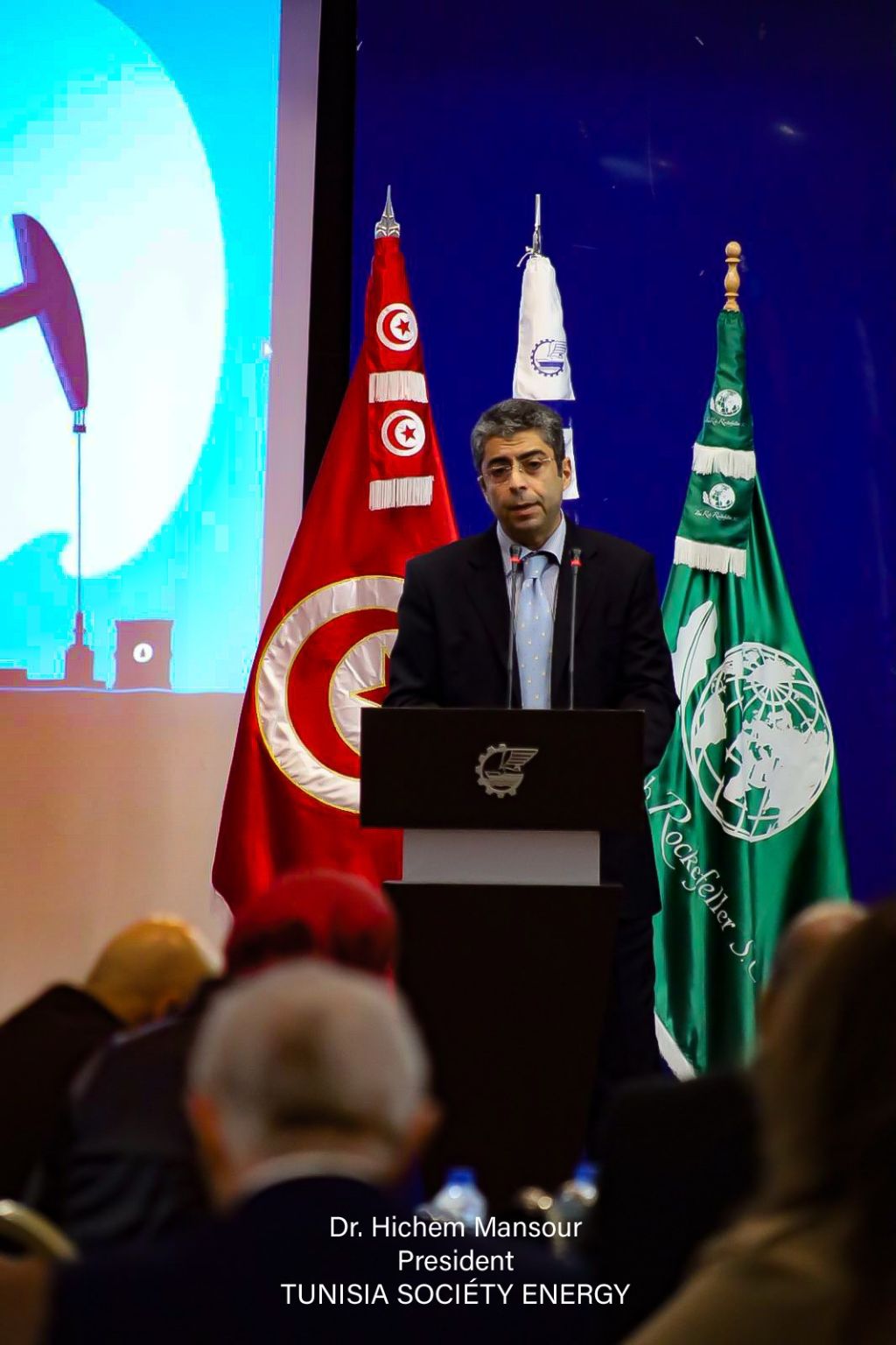 A speaker at the North Africa Oil & Gas forum lectern in Tunis