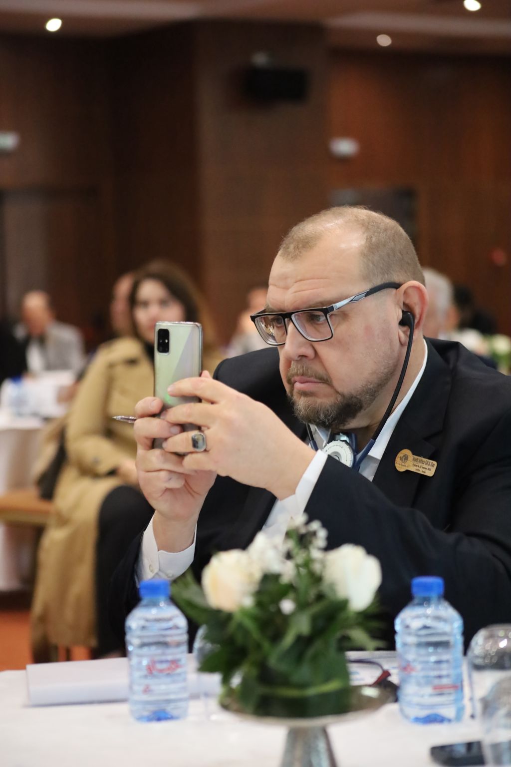 A forum participant seated at a table in the conference hall
