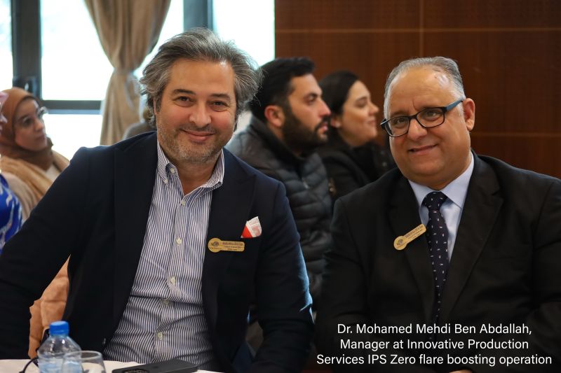 Two participants photographed together at a table during the forum