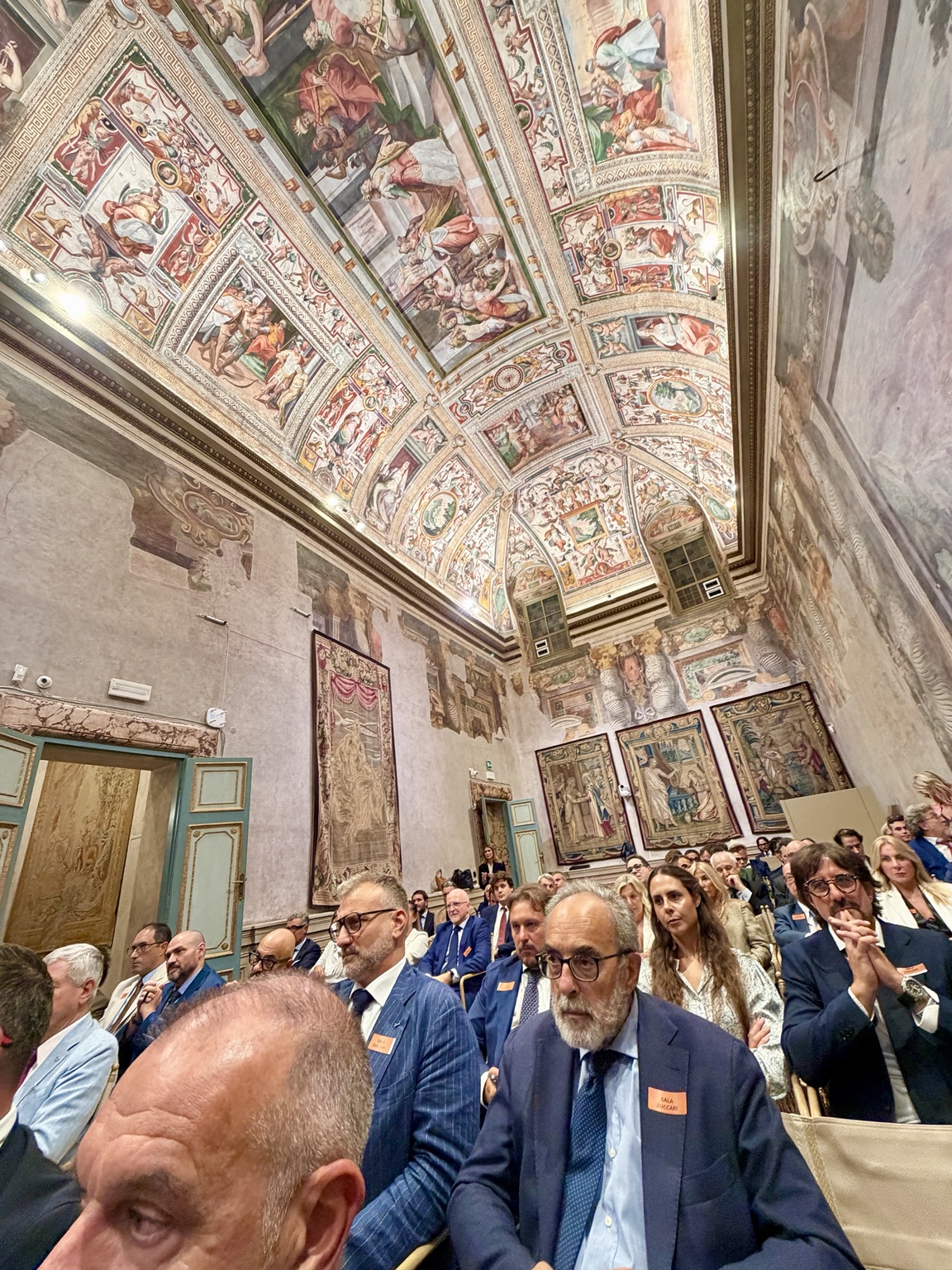 The forum audience beneath the frescoes of Sala Zuccari